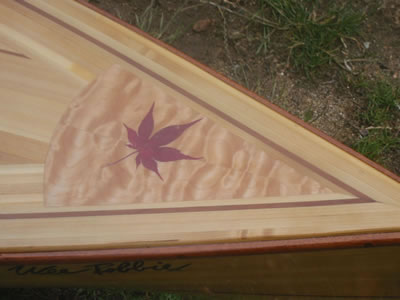 A Japanese maple leaf on the deck of Rob's Wee Lassie